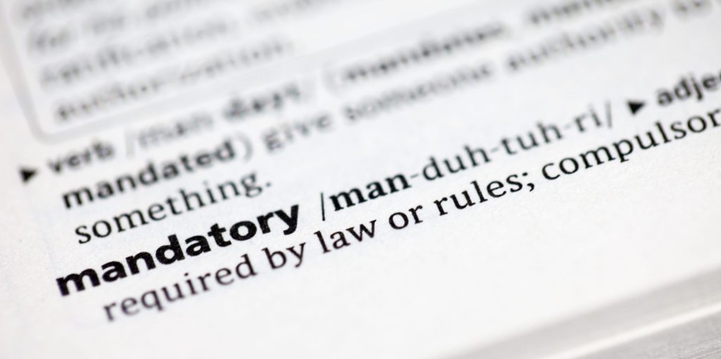 immagine di un dizionario, con definizione di "mandatory" in inglese